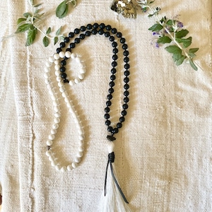 yin yang mala for balance and harmony. white howlite/black onyx/raw tourmaline. leather wrapped silk tassel. 108 beads/ spiritual meditation