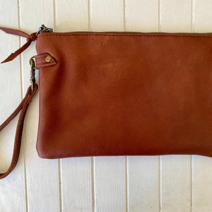 The perfect clutch Black & white cowhide or buttery soft leather wristlet clutch or small crossbody purse. Rust brown