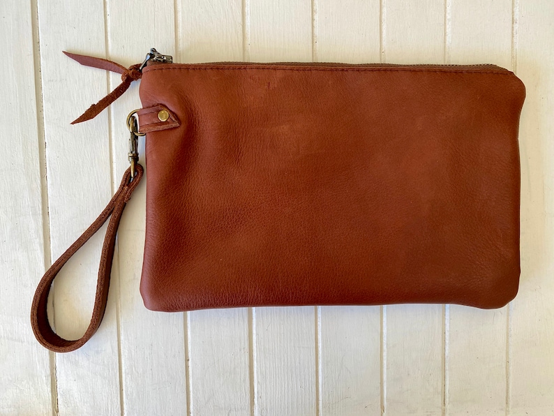 The perfect clutch Black & white cowhide or buttery soft leather wristlet clutch or small crossbody purse. Rust brown