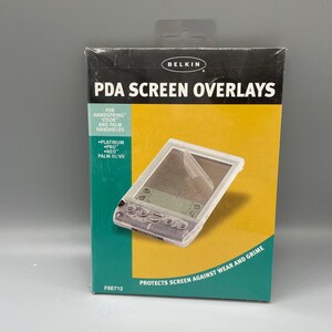 May include: A Belkin PDA screen overlays retail box featuring a yellow and teal design. The packaging displays the text PDA SCREEN OVERLAYS, FOR HANDSPRING VISOR AND PALM HANDHELD, PLATINUM PRO NEO PALM III/VII, and PROTECTS SCREEN AGAINST WEAR AND GRIME.