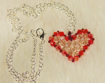 Heart-shaped champagnecolour pendant with red edges - made of crystals and seed beads