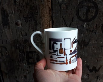 Carpentry China Mug with illustrations by Alice Draws The Line. A range of traditional carpentry hand tools