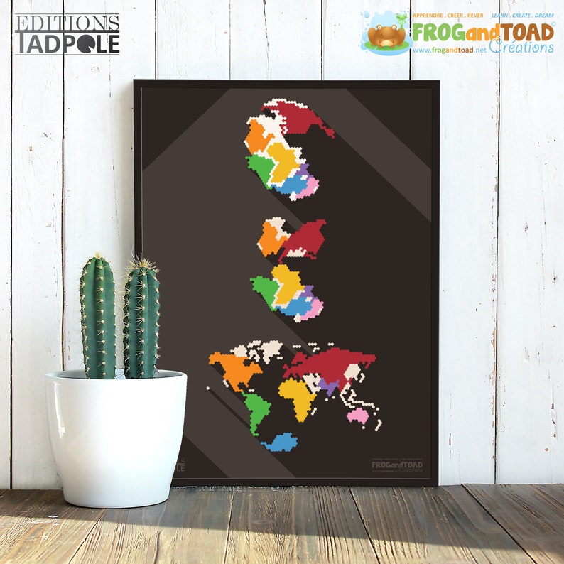 May include: A framed print featuring a pixelated world map in various colors against a dark background. The print includes the text "EDITIONS TADPOLE" and "FROGandTOAD Cr&eacute;ations". A white potted cactus is in the foreground.
