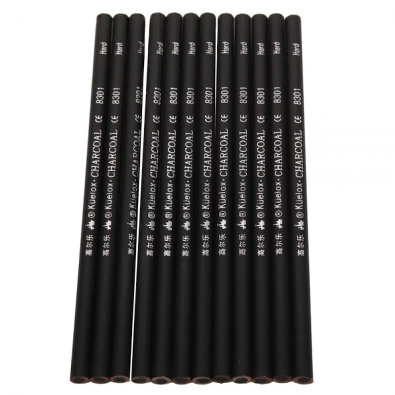 May include: A set of twelve black charcoal pencils with silver lettering that reads "Kuelox Charcoal CE 8301" and "Hard".
