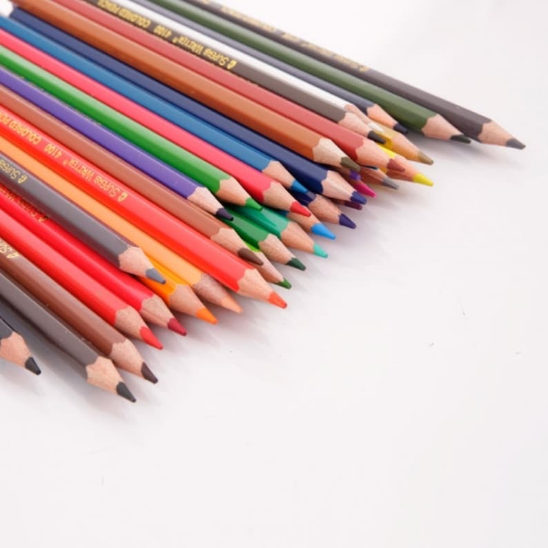 May include: A set of colored pencils with a variety of colors, including red, orange, yellow, green, blue, purple, and brown. The pencils are arranged in a fan shape, with the tips of the pencils pointing towards the right side of the image. The pencils are all sharpened and ready to use.