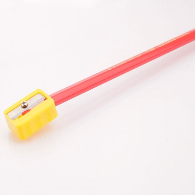 May include: A yellow pencil sharpener attached to a red pencil. The sharpener has a metal blade and a screw.