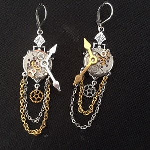 Asymmetrical steampunk earrings with watch mechanism, cogs, chains