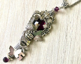 Key necklace decorated with butterflies, bird of paradise and purple Swarovski crystal