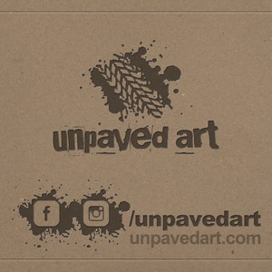 May include: A brown and black logo with the text "unpaved art" and a tire track design. Social media icons for Facebook and Instagram are below the logo with the text "/unpavedart unpavedart.com".