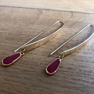 Gold earrings with red enamel pendant