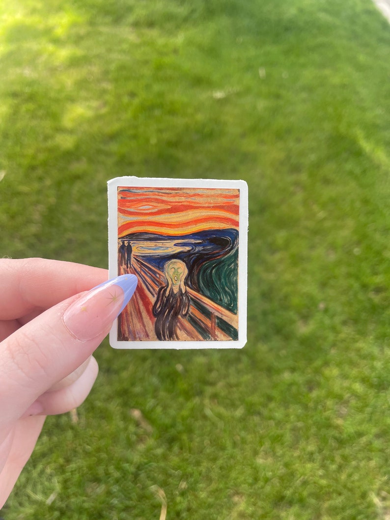 May include: A sticker featuring a reproduction of Edvard Munch's famous painting "The Scream". The painting depicts a figure with a distorted face screaming against a swirling, blood-red sky.