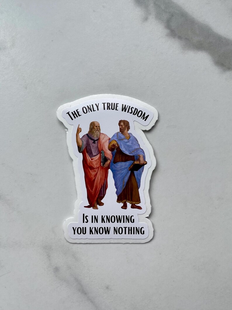 May include: White sticker with a black border featuring two men in Renaissance clothing. The text reads "The only true wisdom is in knowing you know nothing."