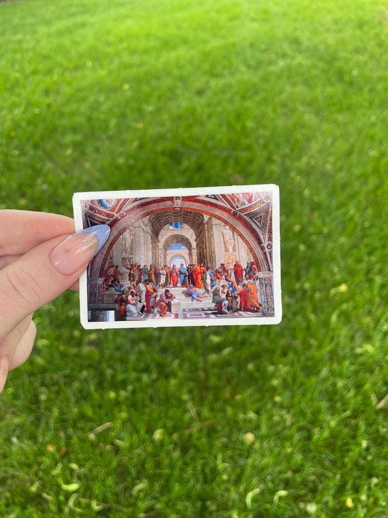 May include: A sticker featuring a painting of a group of people in a large room with a vaulted ceiling. The people are dressed in colorful robes and appear to be engaged in a discussion.