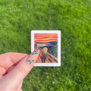 May include: A sticker featuring a reproduction of Edvard Munch's iconic painting "The Scream". The painting depicts a figure with a distorted face and a bright, swirling sky.