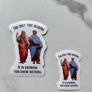 May include: Two white stickers with a black border. Each sticker features a painting of two men in robes. The text on the stickers reads "The only true wisdom is in knowing you know nothing."