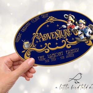 May include: An oval-shaped, navy blue sign with gold lettering and accents. The word "ADVENTURE" is prominently displayed, with the phrase "WHERE DREAMS COME TRUE" above it. Mickey Mouse and another character are depicted. The text "THE LAMONT FAMILY" and dates are also included.