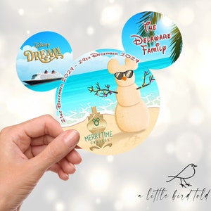 May include: A circular design in the shape of Mickey Mouse ears, depicting a snowman on a beach wearing sunglasses, with the text "21st December 2024 - 24th December 2024". The design includes the words "Disney Dream", "The Delaware Family", and "Merrytime Cruises".