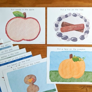 May include: A set of eight printable cards with instructions for a craft activity. Each card features a simple illustration and text that reads "Put seeds in the apple", "Put a fire on the logs", "Put a spider on the web", "Put apples in the tree", "Put an owl on the branch", "Put leaves on the tree", "Put feathers on the turkey", and "Put a face on the pumpkin".