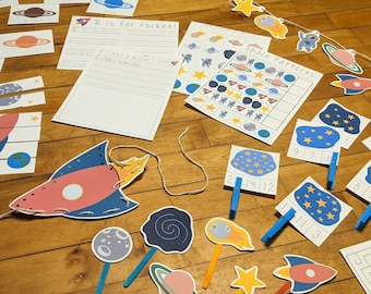 May include: A set of space-themed educational activities for kids, including a rocket ship, planets, stars, and a space-themed maze. The activities are designed to help children learn about space and the solar system.