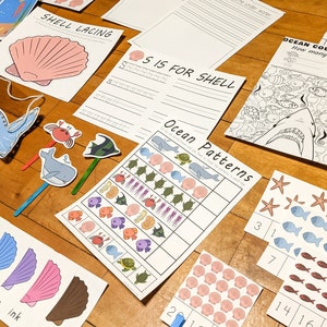 May include: A set of printable ocean-themed educational activities for children. The set includes a shell lacing activity, an ocean count and colour activity, an ocean patterns activity, and an 'S is for Shell' writing activity.