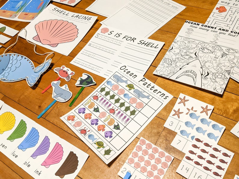 May include: A set of printable ocean-themed educational activities for children. The set includes a shell lacing activity, an ocean count and colour activity, an ocean patterns activity, and an 'S is for Shell' writing activity.