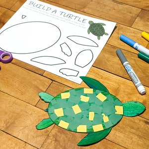 May include: A craft project for making a turtle. The image shows a printed template with a turtle outline, a completed turtle made of green paper and yellow squares, and markers.