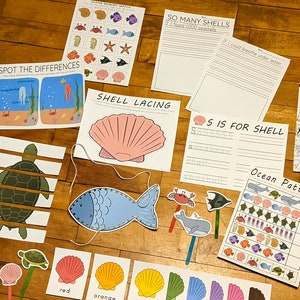 May include: A set of printable ocean-themed educational worksheets for children. The worksheets include activities such as counting shells, tracing letters, and matching pictures. The worksheets are colourful and feature illustrations of sea creatures, shells, and other ocean-related objects.