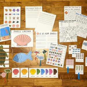 May include: A set of printable ocean-themed educational worksheets for children. The worksheets include activities such as counting, colouring, matching, and tracing. The worksheets feature images of sea creatures such as fish, turtles, crabs, and seahorses.