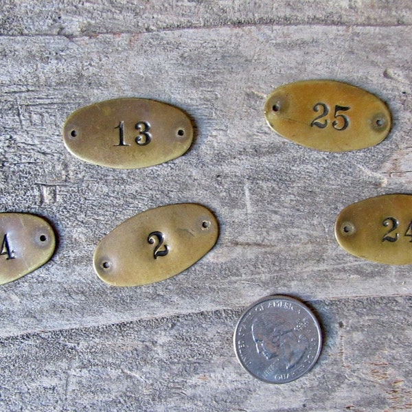 one small vintage brass number tag