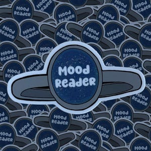 May include: A blue and gray sticker with the text "Mood Reader" in a white circle. The sticker is shaped like a flying saucer.