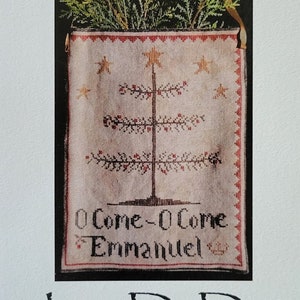 May include: A cross-stitch pattern featuring a stylized Christmas tree with the text "O Come-O Come Emmanuel" and the title "Emmanuel" above the tree. The pattern is from La-D-Da designs for counted thread.