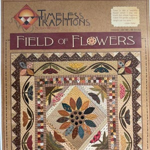 May include: A quilt pattern titled "Field of Flowers" by Norma Whaley. The pattern features a large sunflower in the center surrounded by smaller flowers and leaves. The quilt is made up of a variety of fabrics in shades of brown, green, yellow, red, and blue. The finished size of the quilt is 48 inches by 48 inches.