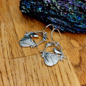 silver earrings with a bird on his nest