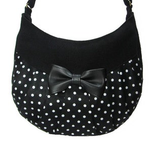 Perfect little black and white dots handbag with faux leather black bow Loli. Crossbody bag with adjustable strap close by zipper.Rockabilly