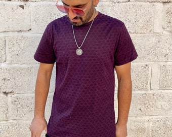 May include: A burgundy t-shirt with a geometric pattern. The shirt has short sleeves and a crew neck.