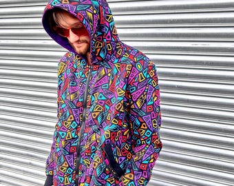 May include: A black hooded sweatshirt with a colourful geometric pattern. The pattern features a variety of shapes and colours, including red, yellow, blue, green, and purple.