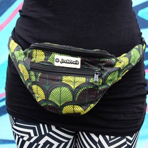 May include: A black fanny pack with a green and yellow leaf pattern. The pack has a zipper closure and a small label that reads "jackfruit".