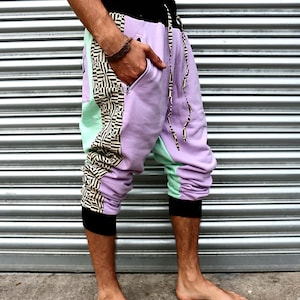 May include: Purple, green, and black patterned pants with a drawstring waist.