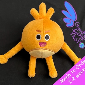 May include: Orange plush toy with a round body, four limbs, and a face with black eyes, a pink mouth, and a brown eyebrow. The toy is made to order and takes 1-2 weeks to ship. The text "Guardian Earth Plush" is visible in the background.
