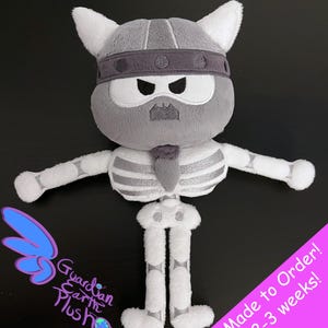 May include: A plush toy in the shape of a Viking skeleton. The toy is primarily gray and white, with a Viking helmet and a skeleton design. The text "Guardian Earth Plus" and "Made to Order! 2-3 weeks!" are also visible.