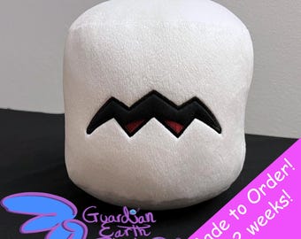 May include: White plush toy shaped like a marshmallow with a black and red zig-zag pattern for a mouth. The toy is made to order and takes 1-2 weeks to ship. "Guardian Earth Plush" is written on the bottom of the image.