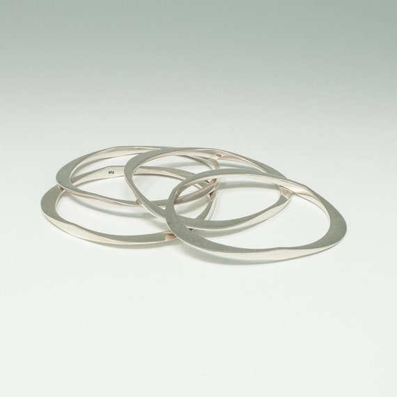 Four Triangular Silver Bangles - image 1