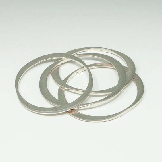 Four Oval Silver Bangles - image 1