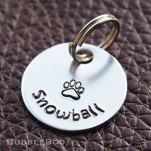 Personalised Pet Tag. Put your pet's name on an aluminium round disc featuring a hand-stamped paw print. Pet Id Tag. Name Tag.