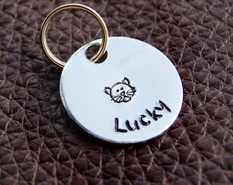 Personalised Cat Tag. Put your cat's name on an aluminium round disc featuring a hand-stamped cat. Pet Id Tag. Pet Name Tag. Gift Boxed.