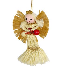 May include: A handcrafted angel ornament with a straw-like body, wings, and hair. The angel has a painted face, a gold crown, and holds two round ornaments. A gold string is attached for hanging. The angel is a festive holiday decoration.
