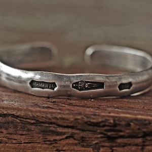 Steel punch imprinted memento mori silver cuff bracelet