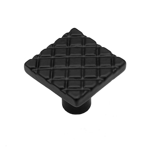 May include: Black square cabinet knob with a textured diamond pattern.