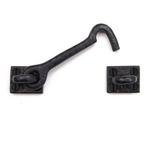 May include: Black metal hook and eye latch set. The hook is attached to a square plate with four screws. The eye is attached to a separate square plate with four screws.