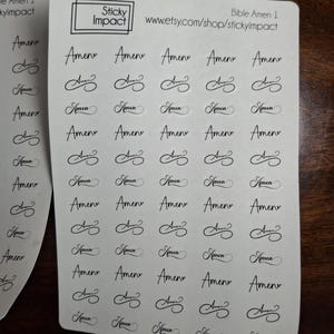 May include: Sheets of stickers with the word "Amen" in a cursive font. The stickers are black on a white background. The text "Sticky Impact" and a website address are also visible.